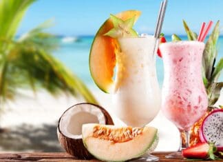 Two milkshakes with tropical fruits on a beach with ocean view, 2K Desktop Wallpaper