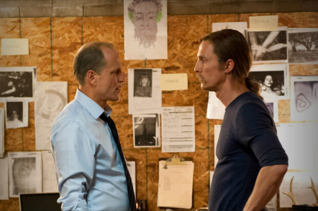 Two men discuss a case in a room with pinned up documents, HD Desktop Wallpaper