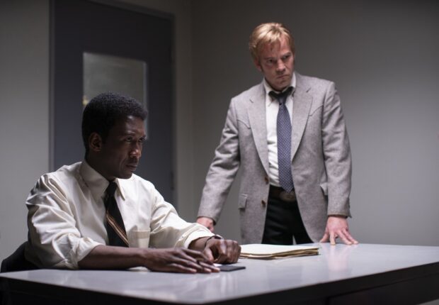 Two detectives discuss a case during an intense interrogation, HD Desktop Wallpaper