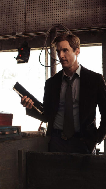 A man is studying evidence carefully in a dimly lit room from True Detective tv series wallpapers, HD Phone Wallpaper