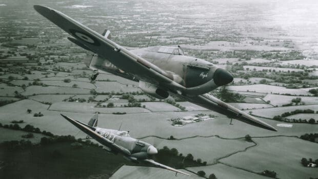 Two Hawker Hurricane planes fly over the countryside during an aerial mission, 2K Desktop Wallpaper