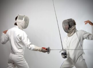 Two fencers in full gear face each other during a fencing match, HD Desktop Wallpaper