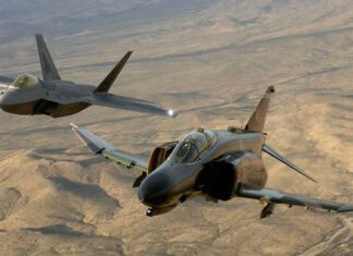 Two jet fighters flying over a vast desert landscape during sunset, 2K Desktop Wallpaper