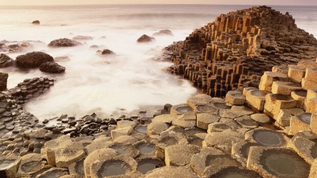 The Giants Causeway rock formation glows under soft morning light by the sea, HD Desktop Wallpaper