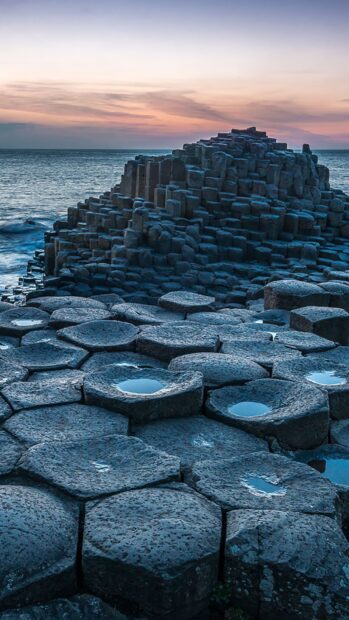 The Giants Causeway shows hexagonal basalt columns by the ocean at sunset, HD Phone Wallpaper