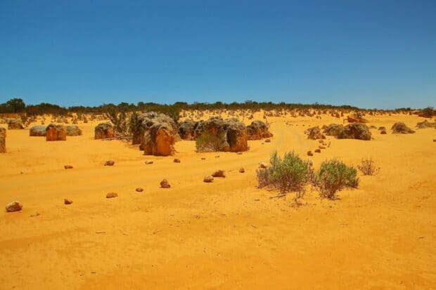 The desert scene with unique rock formations and sparse shrubs showcases Nambung National Park, HD Desktop Wallpaper