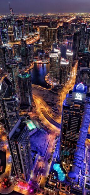 A vibrant night view of the United Arab Emirates city lights and skyscrapers, 2K Mobile Wallpaper