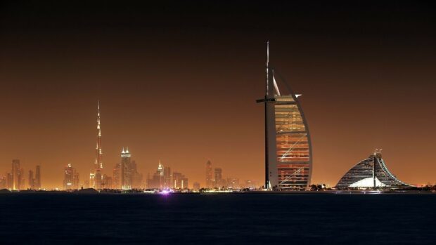 The United Arab Emirates skyline features iconic skyscrapers illuminated against the night sky, HD Desktop Wallpaper