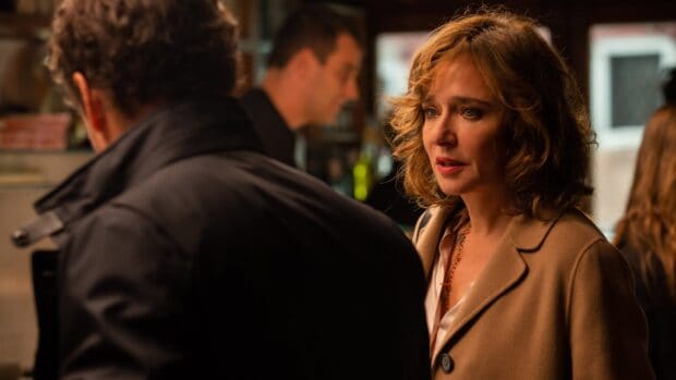 Valeria Golino is seen deeply engaged in a conversation with blurred people in the background, 4K Desktop Wallpaper