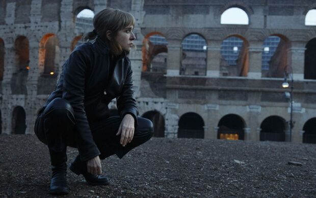 A woman crouching in a leather jacket near the Colosseum in Rome in Valeria Golino wallpapers, HD Desktop Wallpaper