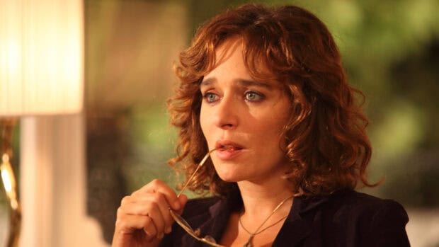 Valeria Golino in a thoughtful moment holding glasses near her mouth, 4K Desktop Wallpaper