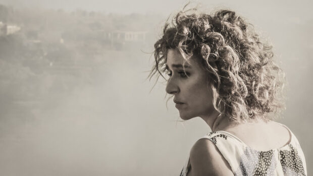 Valeria Golino is shown in a thoughtful pose looking sideways, HD Desktop Wallpaper