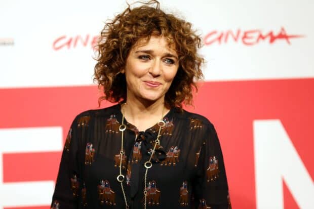 Valeria Golino poses wearing a patterned blouse and necklace at a cinema event, HD Desktop Wallpaper