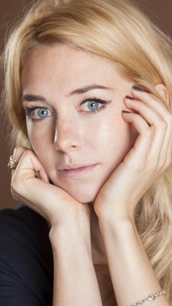 Vanessa Kirby wallpapers showing a thoughtful expression with hands near the face, 2K Mobile Wallpaper