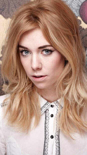 A close up of Vanessa Kirby with blonde hair and blue eyes wearing a white shirt, 2K Mobile Wallpaper