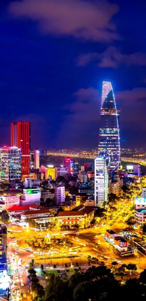 Vietnam Wallpapers capture the vibrant city lights and modern buildings in Ho Chi Minh City, 2K Mobile Wallpaper