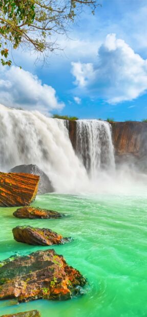 Vietnam Wallpapers showing a peaceful waterfall with clear surroundings and blue sky, 2K Mobile Wallpaper