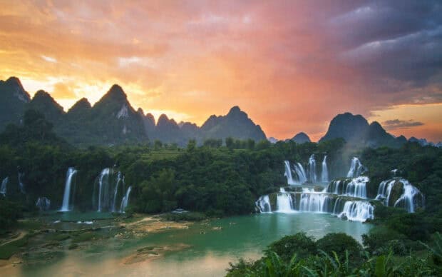 Vietnam Wallpapers showing beautiful waterfalls and lush mountains at sunset, HD Desktop Wallpaper