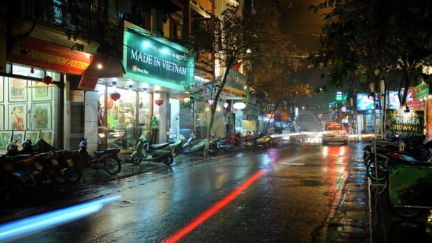 Vietnam Wallpapers capture a rainy urban street with lights reflecting on wet pavement, HD Desktop Wallpaper