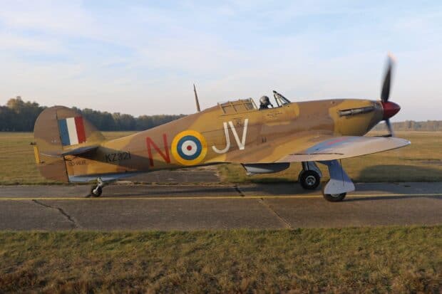 A Hawker Hurricane aircraft is taxiing on a runway under a clear sky, HD Desktop Wallpaper
