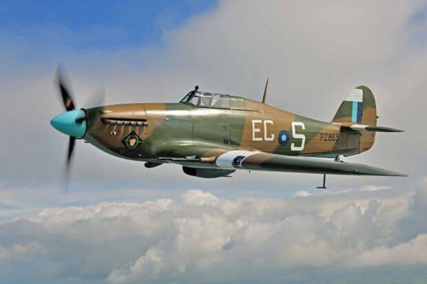 A Hawker Hurricane is captured soaring through a partly cloudy sky during flight, HD Desktop Wallpaper