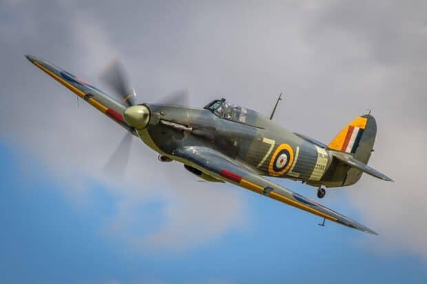 A Hawker Hurricane aircraft flies through a partly cloudy sky during the day, HD Desktop Wallpaper