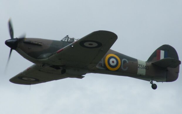 A vintage Hawker Hurricane aircraft flies against a cloudy sky, HD Desktop Wallpaper