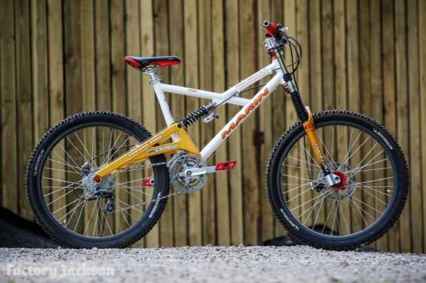 A vintage Marin Bikes is pictured with detailed parts and knobby tires on a gravel surface, HD Desktop Wallpaper