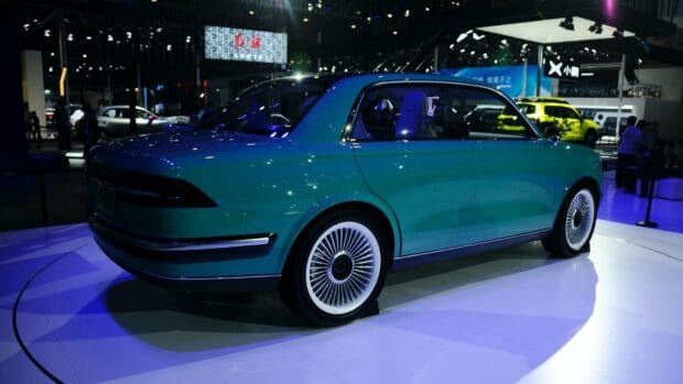 A vintage style Great Wall Motors car is displayed with blue lighting in a showroom, HD Desktop Wallpaper