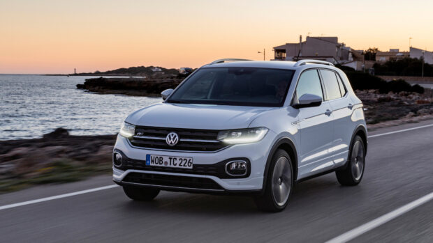 A white Volkswagen T Cross driving on a coastal road during sunset, 4K Desktop Wallpaper
