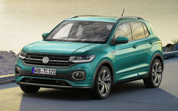 The Volkswagen T Cross is parked by a waterfront with clear skies reflecting on its windows, HD Desktop Wallpaper