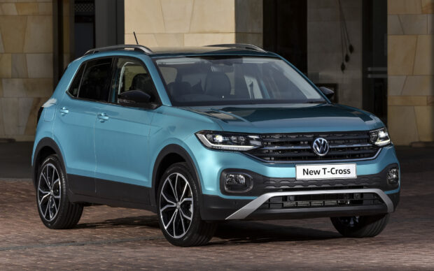 A blue Volkswagen T Cross is parked outside a building showing the front and side design, HD Desktop Wallpaper