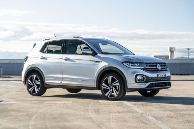 A silver Volkswagen T Cross parked outdoors under a partly cloudy sky, 2K Desktop Wallpaper