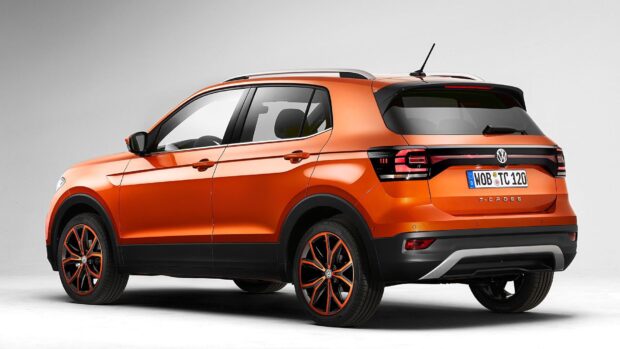 A bright orange Volkswagen T Cross SUV is shown from the rear side, highlighting its sleek design and taillights, HD Desktop Wallpaper
