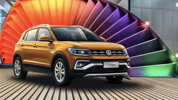 A yellow Volkswagen T Cross is parked indoors near a vibrant multi colored spiral wall, 2K Desktop Wallpaper