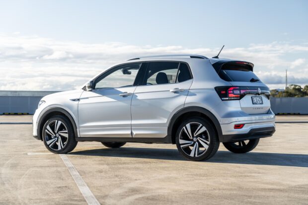 A silver Volkswagen T Cross is parked in an outdoor parking lot under a cloudy sky, 2K Desktop Wallpaper