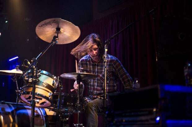 A drummer from Vundabar band is intensely playing drums on stage during a live performance, HD Desktop Wallpaper