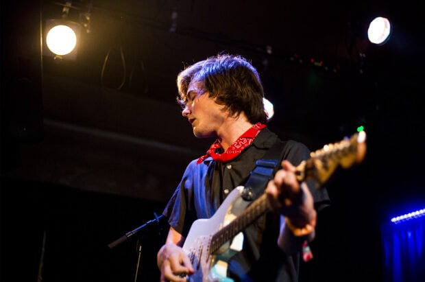 A Vundabar band guitarist passionately plays an electric guitar during a live performance, HD Desktop Wallpaper