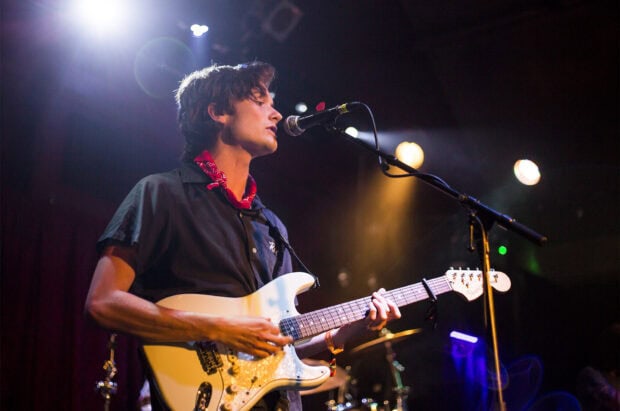 A guitarist from Vundabar band plays electric guitar on stage with colorful lights, HD Desktop Wallpaper