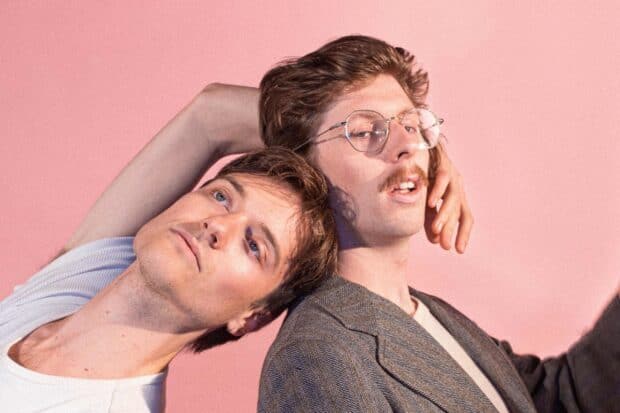 Two Vundabar Band members posing against a pink background, 2K Desktop Wallpaper