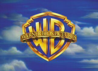 The Warner Bros logo is displayed against a cloudy blue sky with Warner Bros Wallpapers text, 2K Desktop Wallpaper