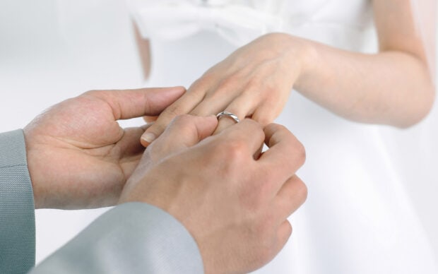 A man is placing a wedding ring on a woman’s finger during a ceremony, HD Desktop Wallpaper