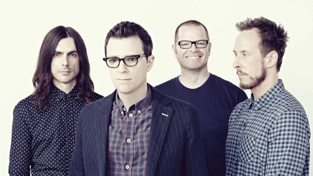 The Weezer band members pose for a promotional photo wearing casual outfits and glasses, HD Desktop Wallpaper