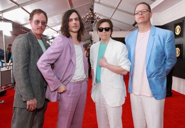 The Weezer band members are standing together on a red carpet at an event, 2K Desktop Wallpaper