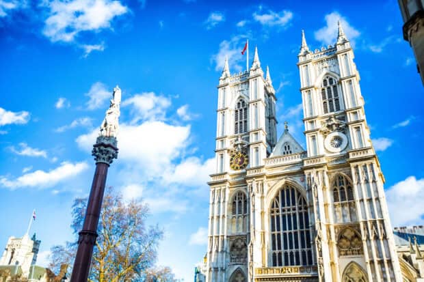 Westminster Abbey stands tall with detailed architecture against bright blue skies, HD Desktop Wallpaper