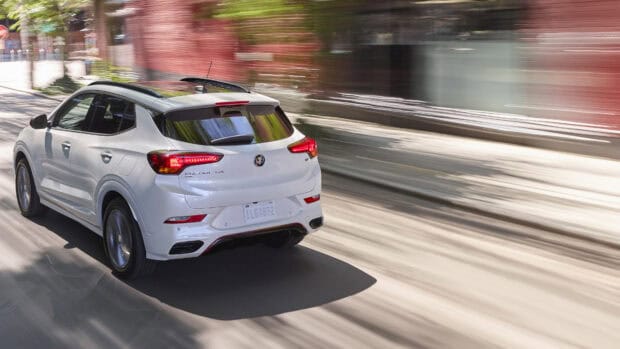 A white Buick Encore is driving fast through an urban area with motion blur, 4K Desktop Wallpaper