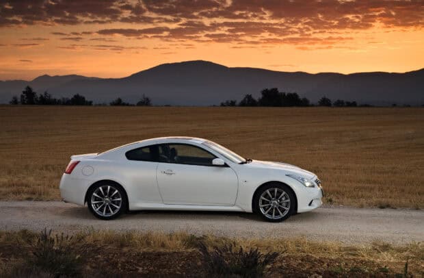 A white Infiniti G37 is parked on a dirt road with a sunset and mountains in the background, HD Desktop Wallpaper