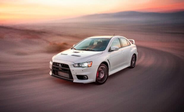 A white Lancer Evo is driving fast on a dusty road during sunset, HD Desktop Wallpaper