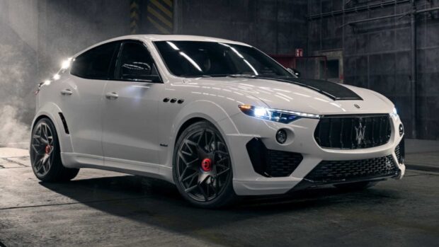 A white Maserati Levante is parked in a dark garage with illuminated headlights, HD Desktop Wallpaper