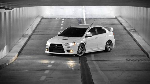 A white Mitsubishi Lancer Evo is parked in the middle of an empty tunnel with lights on, HD Desktop Wallpaper